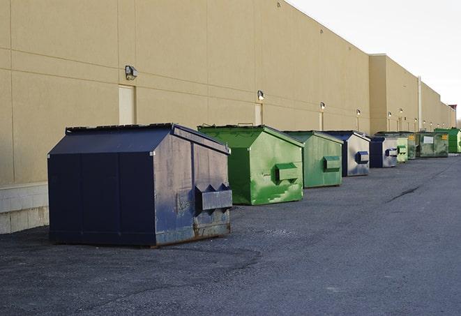 a construction worker moves construction materials near a dumpster in Bridgewater, MI